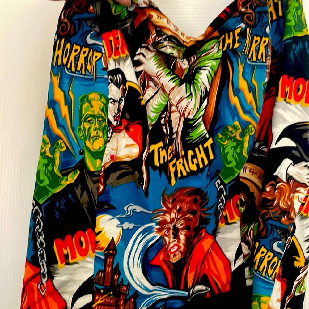 Black dress with monsters on top.  Great dress!  Size Small